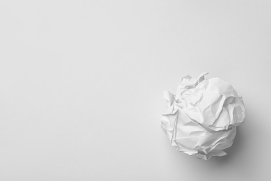 Crumpled sheet of paper on white background, top view