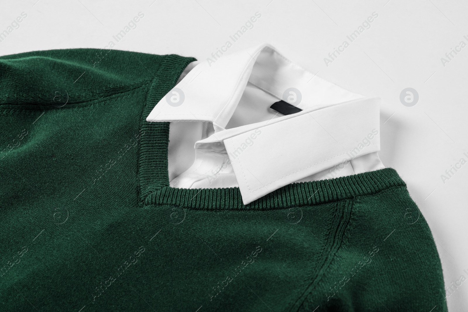 Photo of New stylish school uniform on white background, closeup