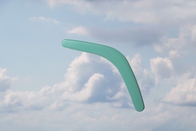 Throwing of boomerang against blue sky. Outdoor activity 