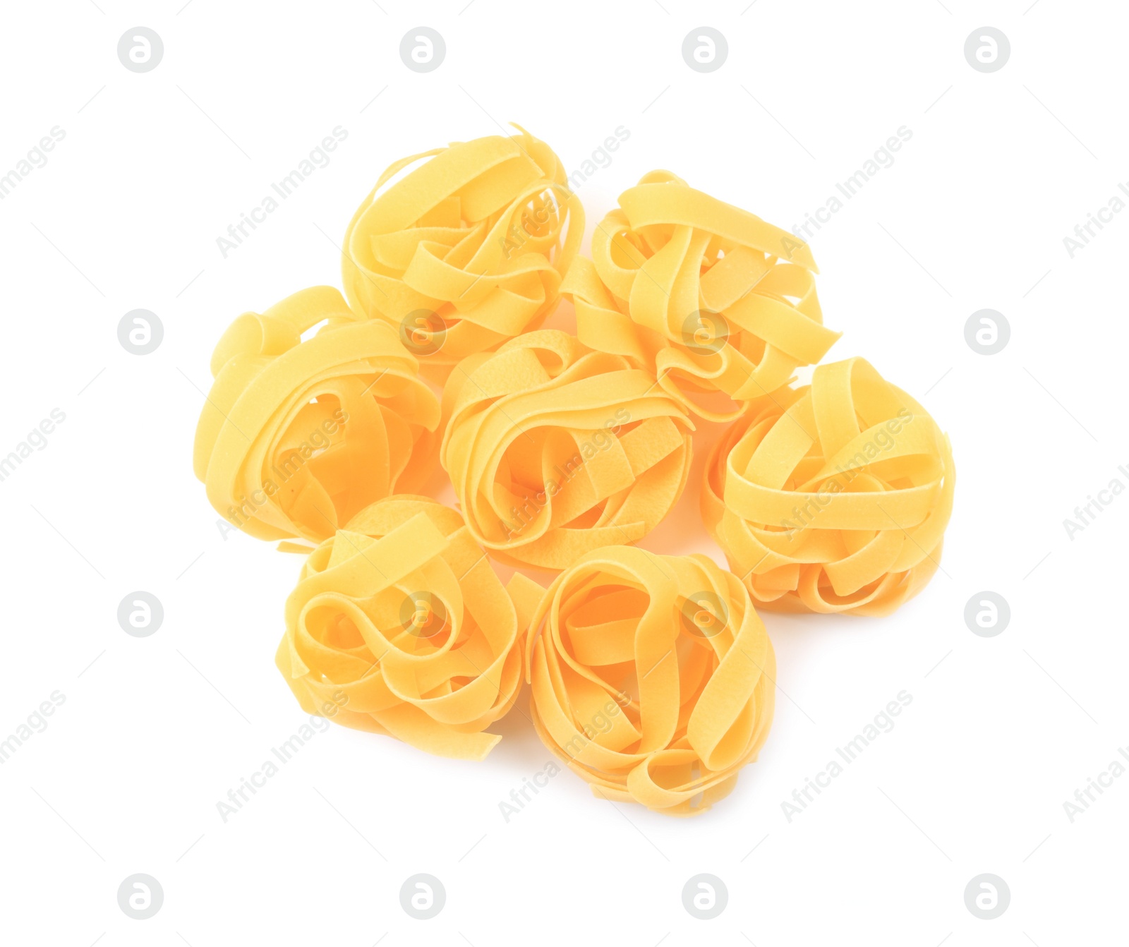 Photo of Raw fettuccine pasta isolated on white, top view