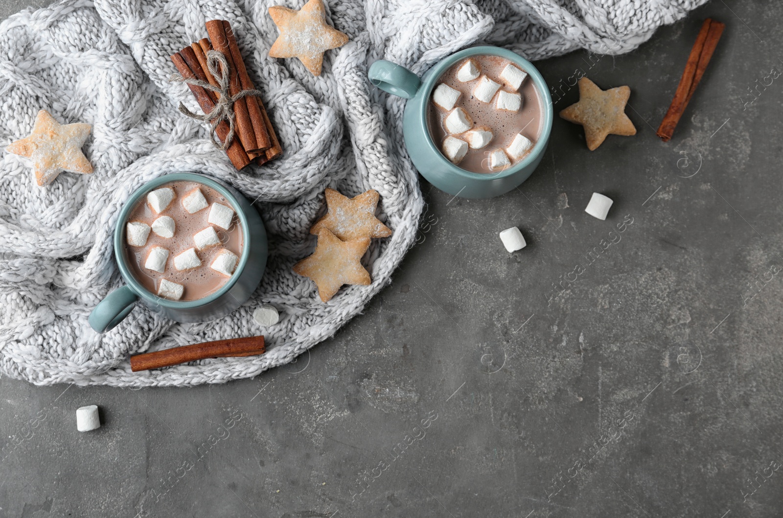 Photo of Composition with delicious hot cocoa drink and cookies on dark grey background, flat lay