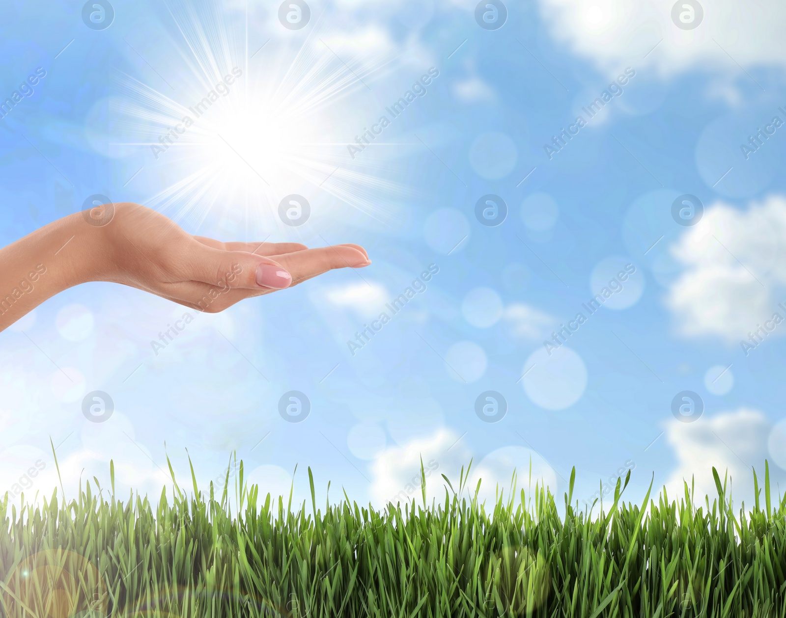 Image of Bright light in hand, closeup. Solar energy concept