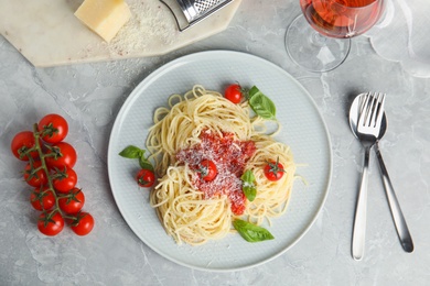 Flat lay composition with tasty pasta on light grey marble table