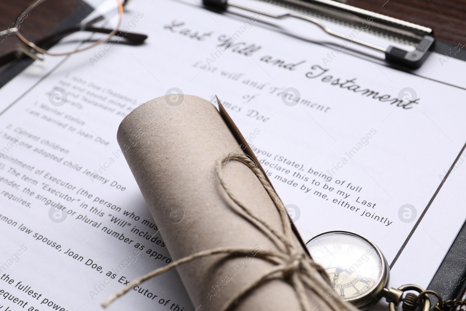 Photo of Last Will and Testament, glasses and scroll on table, closeup