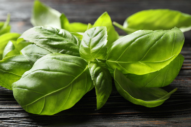 Fresh green basil on black wooden table, closeup