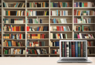 Digital library concept. Modern laptop on table indoors, space for text