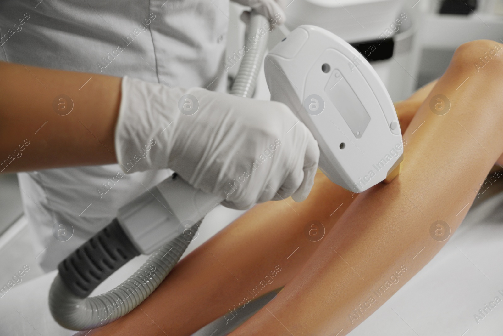 Photo of Woman undergoing laser epilation procedure in beauty salon, closeup