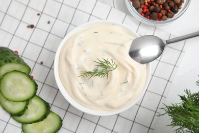 Tasty creamy dill sauce and ingredients on white table, flat lay