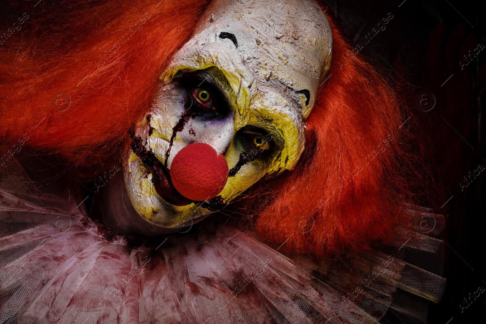 Photo of Portrait of terrifying clown, closeup. Halloween party costume