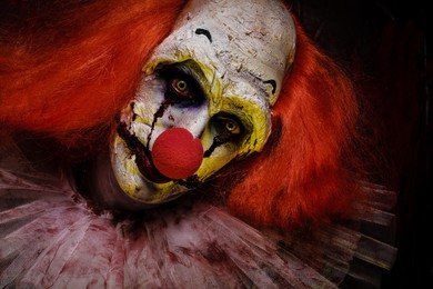 Photo of Portrait of terrifying clown, closeup. Halloween party costume