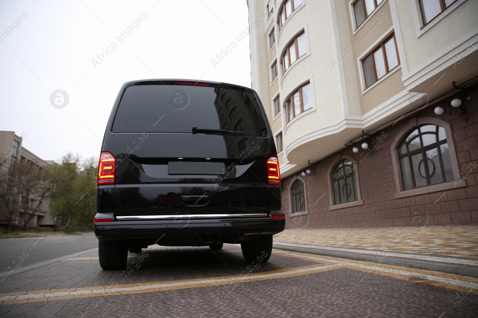 Photo of Black delivery van parked on street near building