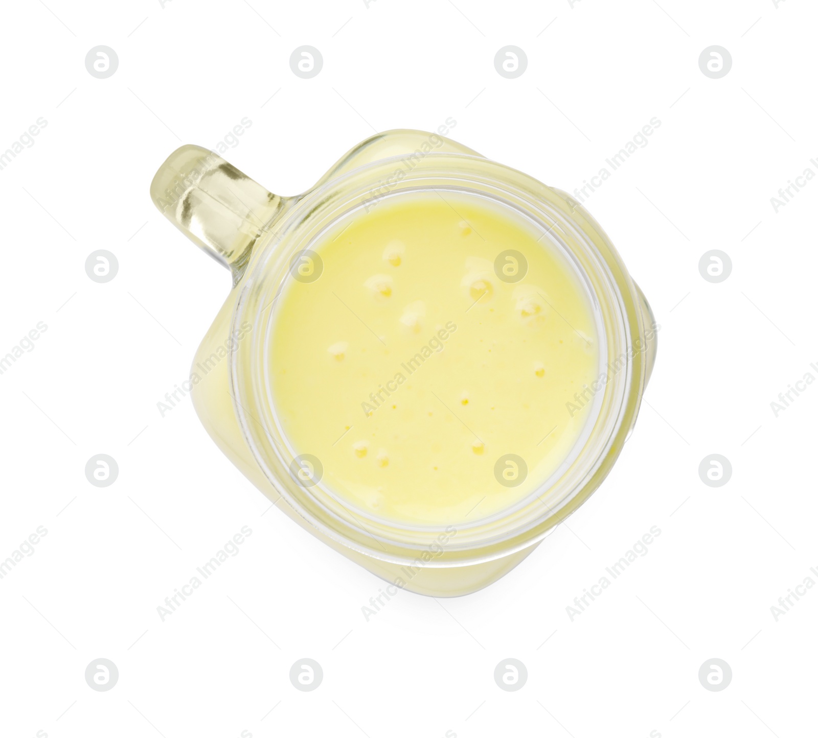 Photo of Tasty pineapple smoothie in mason jar isolated on white, top view