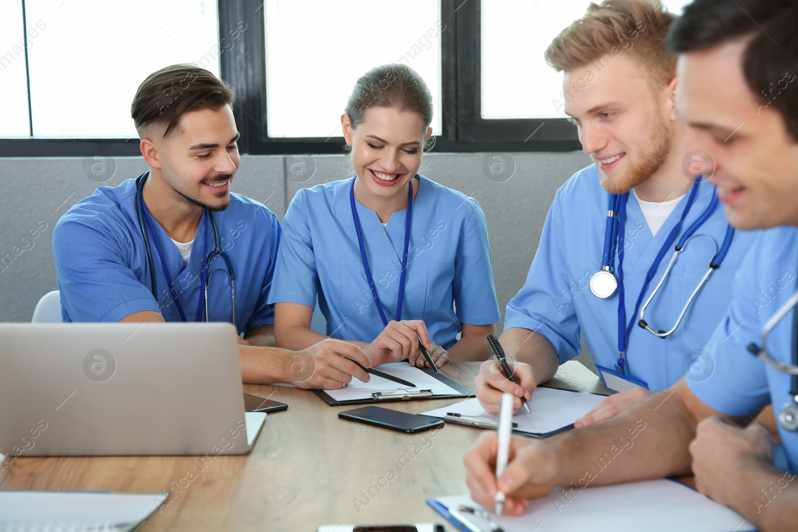 Photo of Medical students in uniforms studying at university