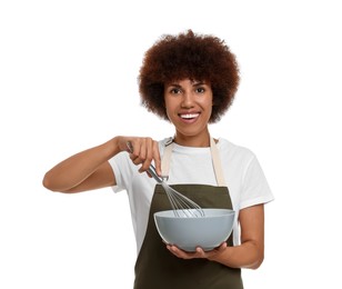 Happy young woman in apron holding bowl and whisk on white background
