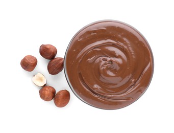 Bowl with delicious chocolate paste and hazelnuts on white background, top view