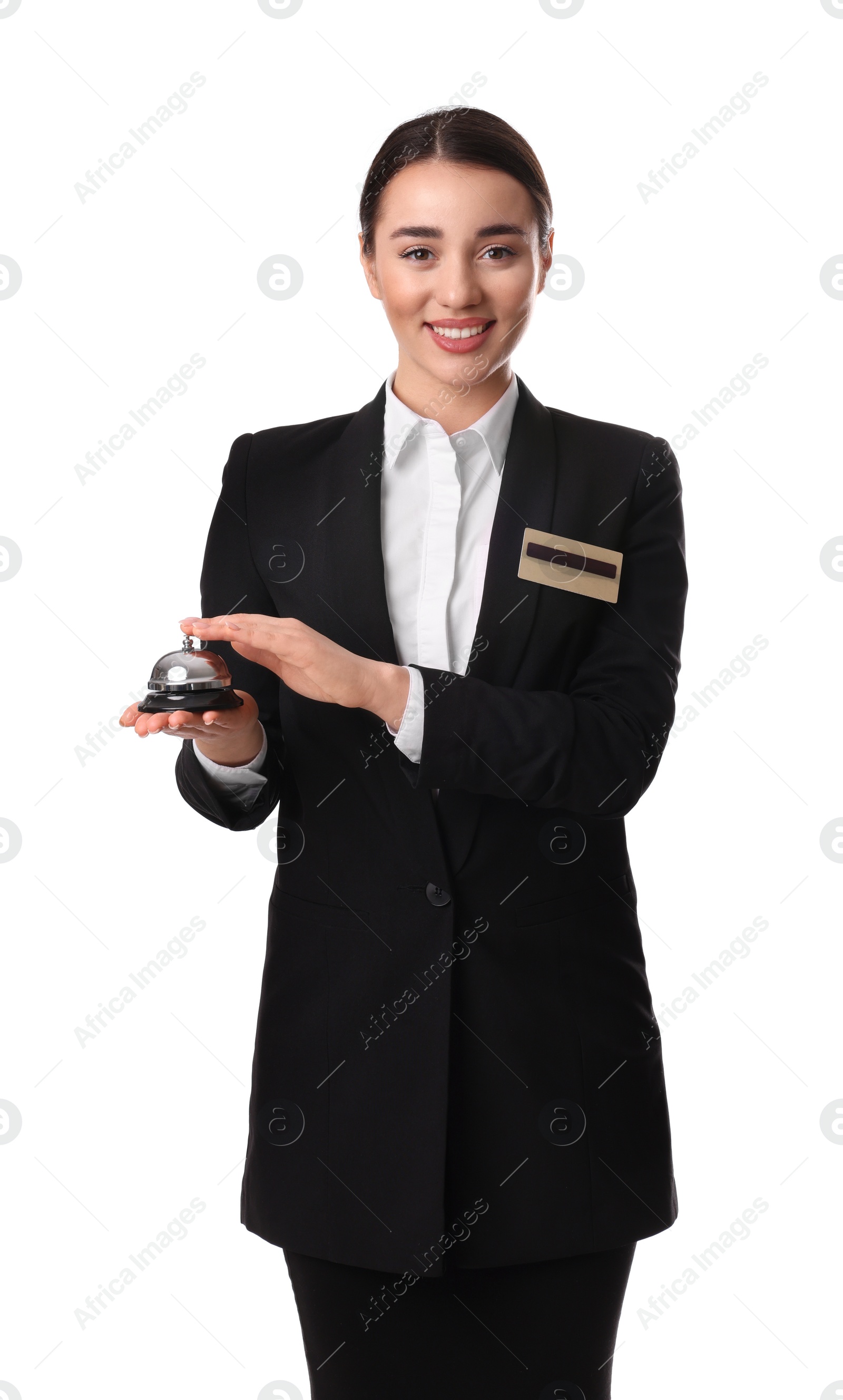 Photo of Happy young receptionist in uniform holding service bell on white background