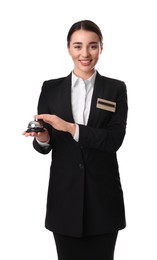 Happy young receptionist in uniform holding service bell on white background