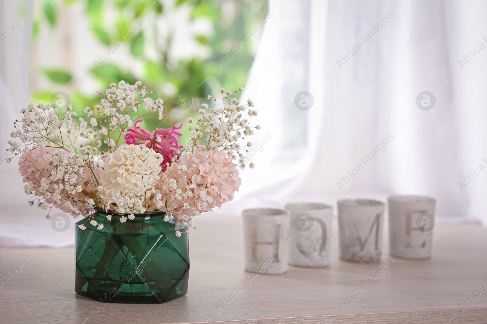 Photo of Beautiful fresh flowers on window sill indoors