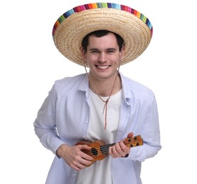 Young man in Mexican sombrero hat playing ukulele on white background