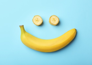 Funny flat lay composition with bananas on color background