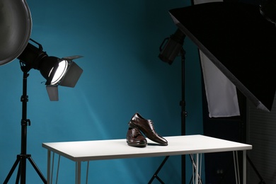 Photo of Shooting of men's shoes for product promotion in photo studio