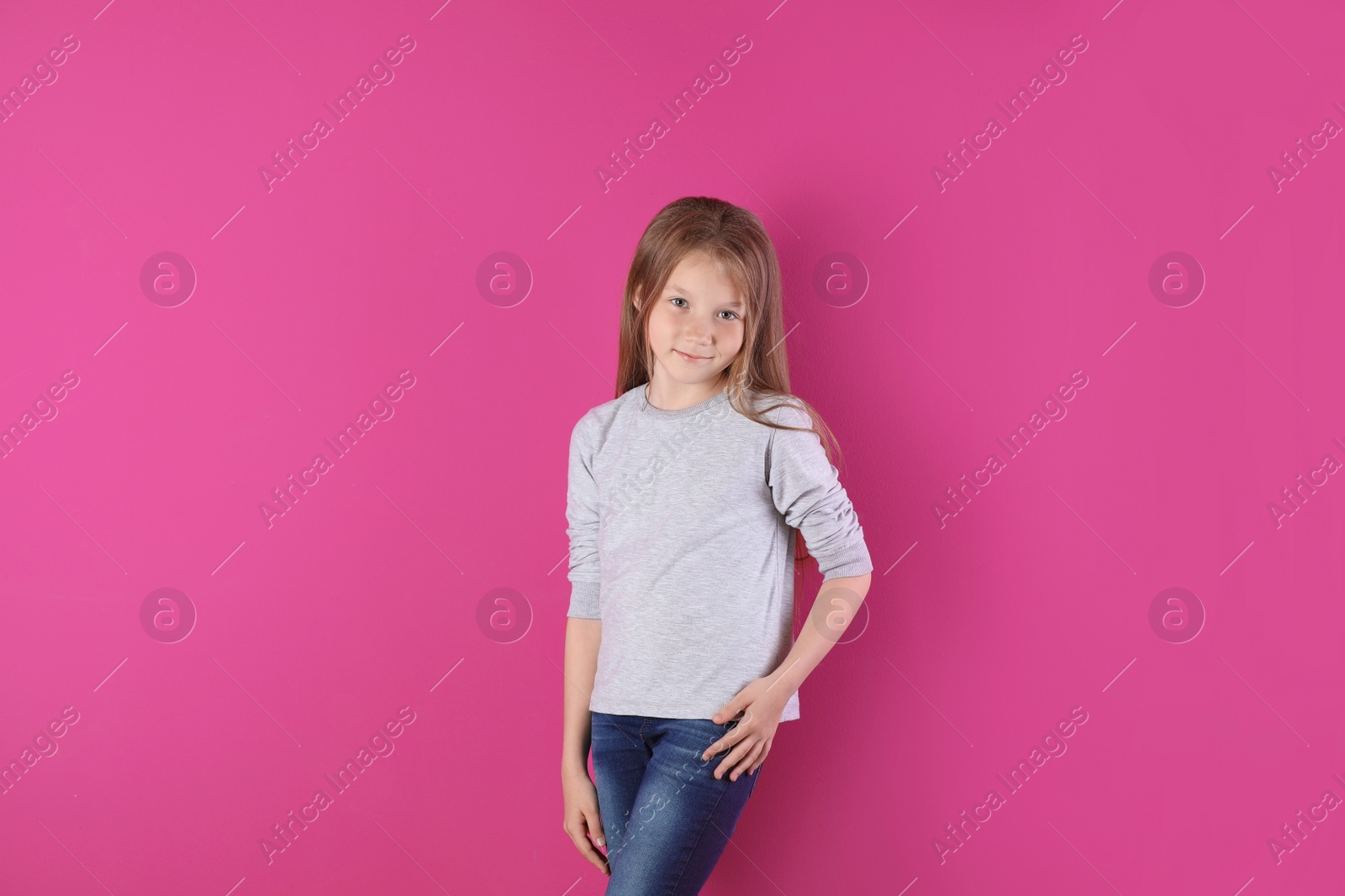 Photo of Little girl in long sleeve t-shirt on color background. Mockup for design