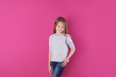 Little girl in long sleeve t-shirt on color background. Mockup for design