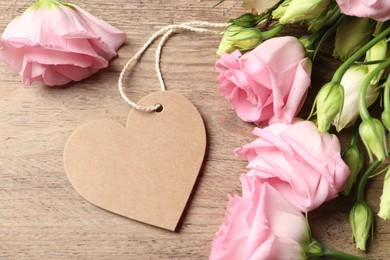 Photo of Happy Mother's Day. Beautiful flowers and blank heart shaped card on wooden table