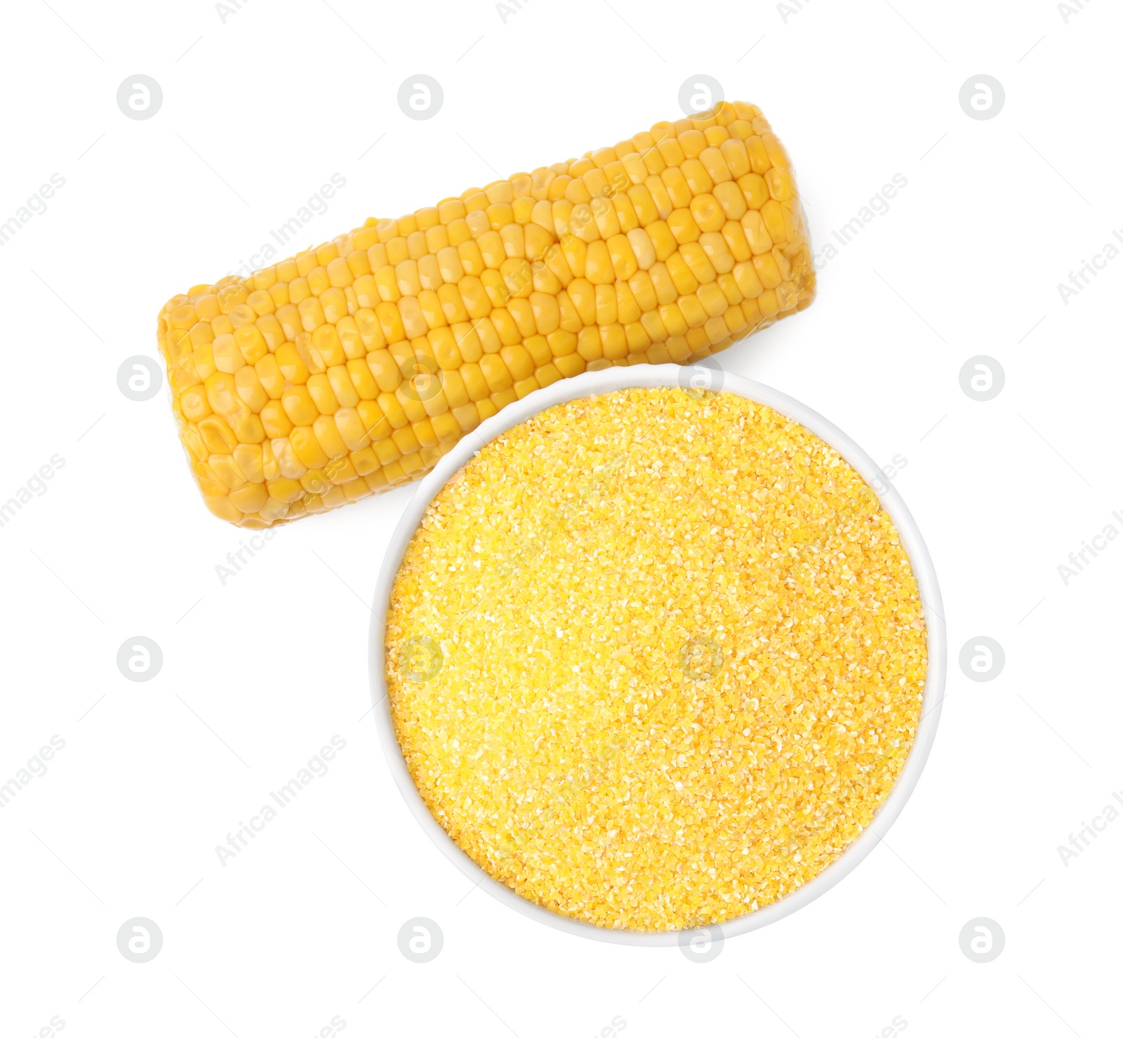 Photo of Raw cornmeal in bowl and corn cob isolated on white, top view