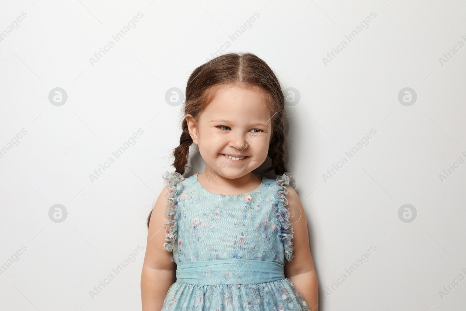 Photo of Cute little girl on light grey background