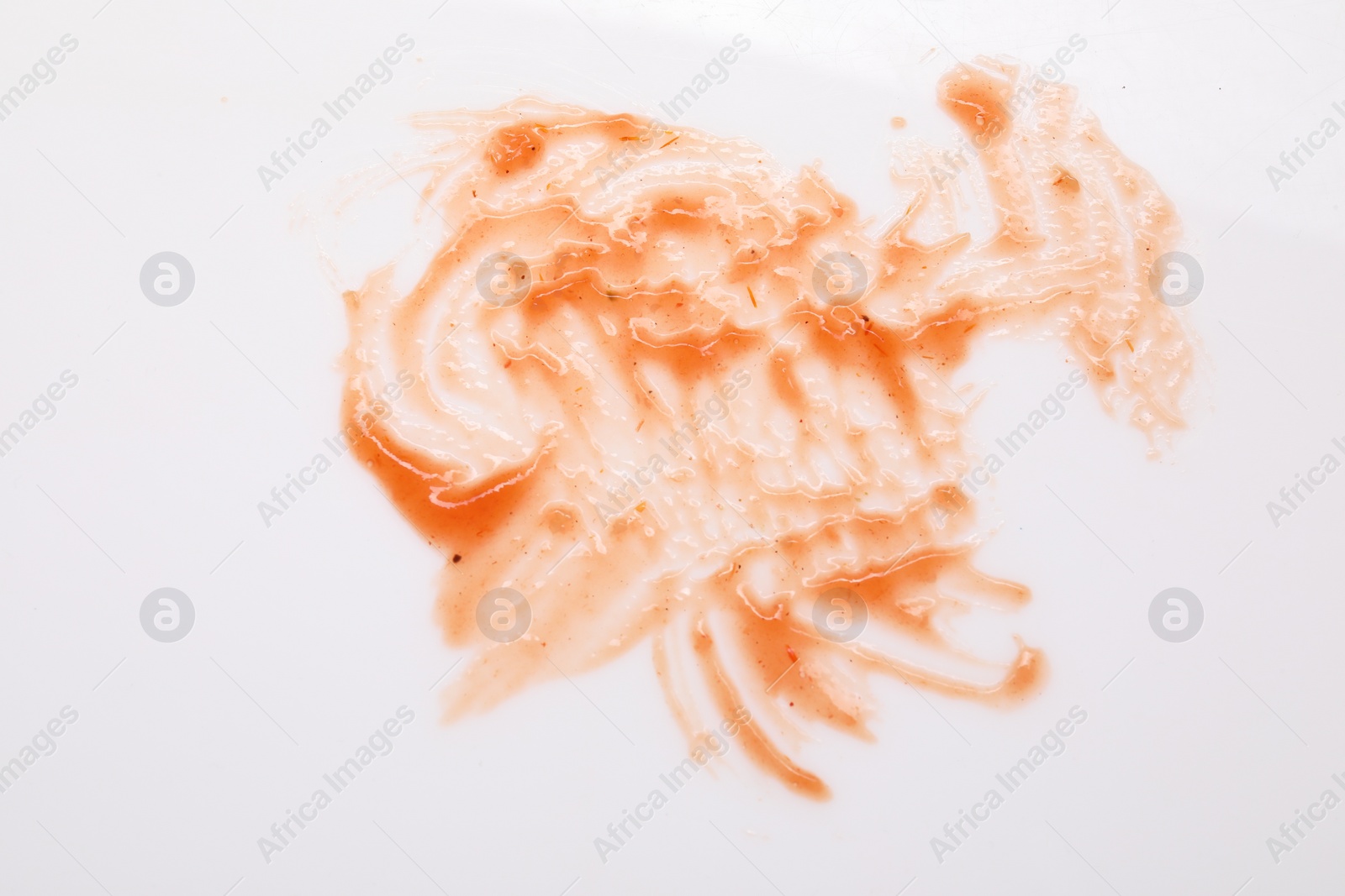 Photo of Smear of sauce on white background, top view