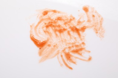 Photo of Smear of sauce on white background, top view