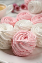 Photo of Delicious white and pink marshmallows on plate, closeup