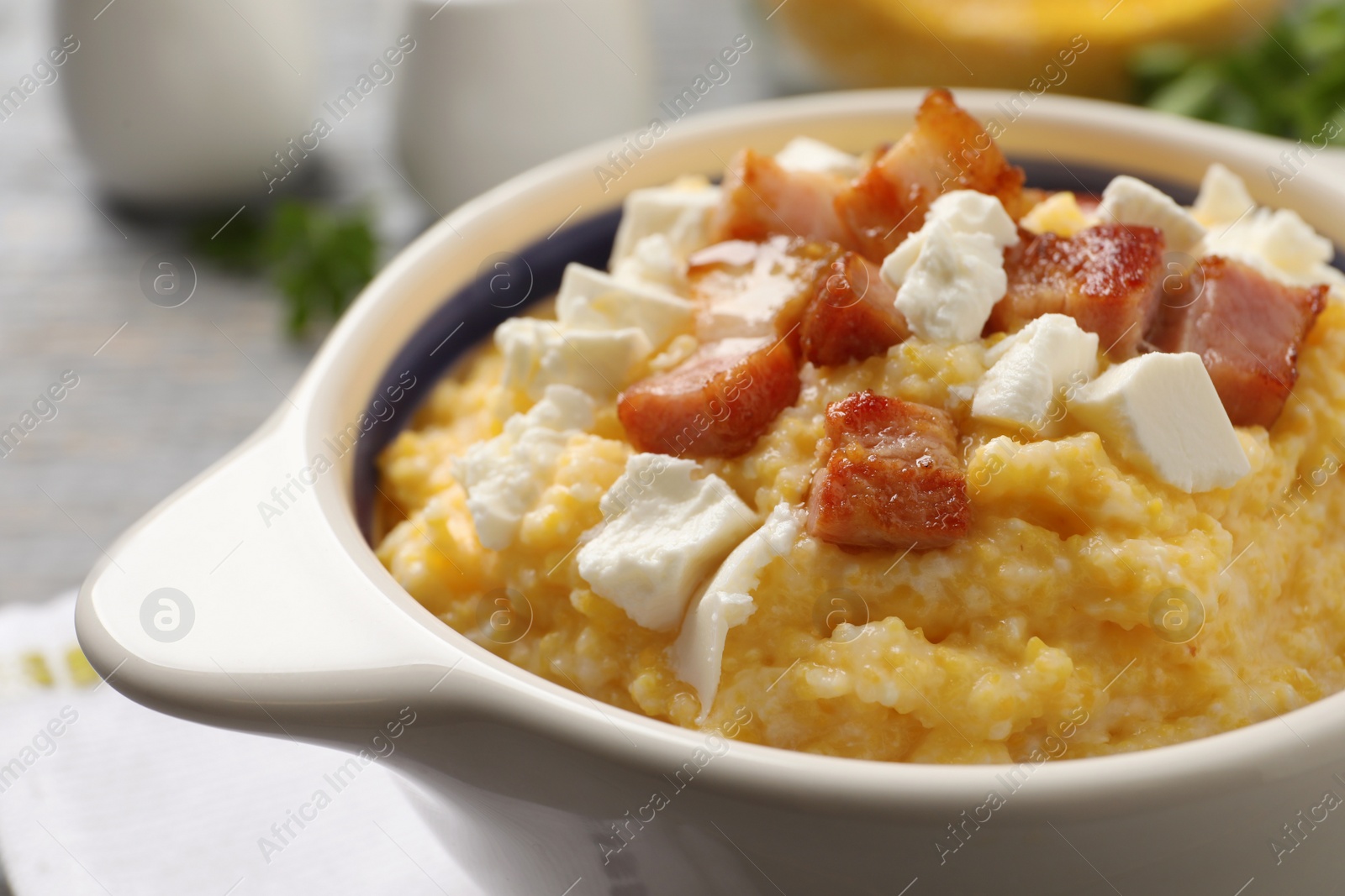 Photo of Delicious traditional Ukrainian banosh in bowl on table, closeup