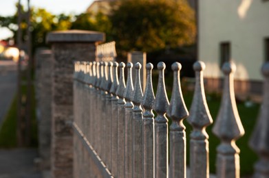 Photo of Beautiful iron fence on sunny day outdoors, closeup