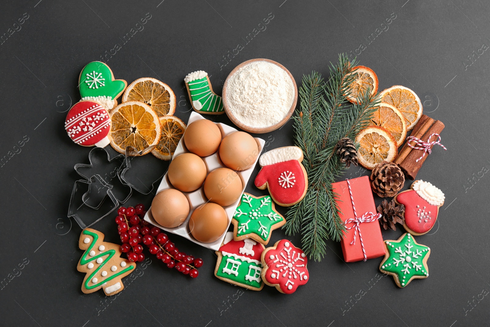 Photo of Flat lay composition with homemade Christmas cookies and ingredients on black background