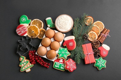 Photo of Flat lay composition with homemade Christmas cookies and ingredients on black background