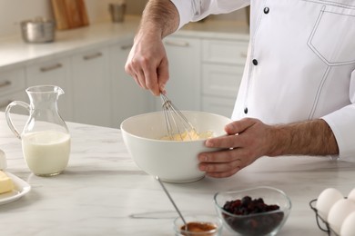 Professional chef making dough at white marble table indoors, closeup