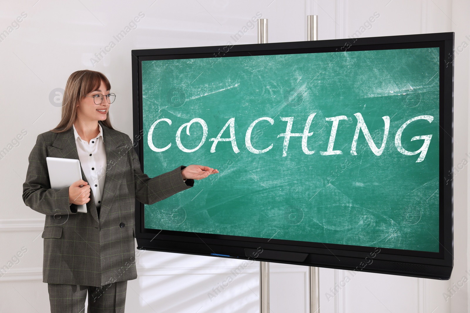 Photo of Business trainer using interactive board in meeting room