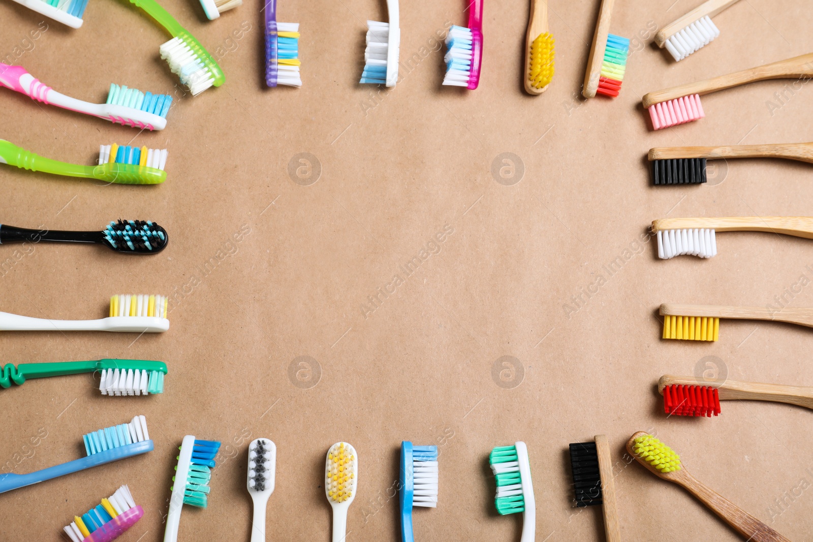 Photo of Flat lay composition with plastic and bamboo toothbrushes on beige background, space for text. Recycling concept