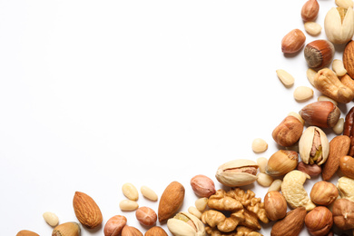 Photo of Different delicious nuts on white background, flat lay. Space for text