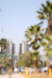 Photo of San Pedro Garza Garcia, Mexico – March 20, 2023: Blurred view of city with buildings and green palms