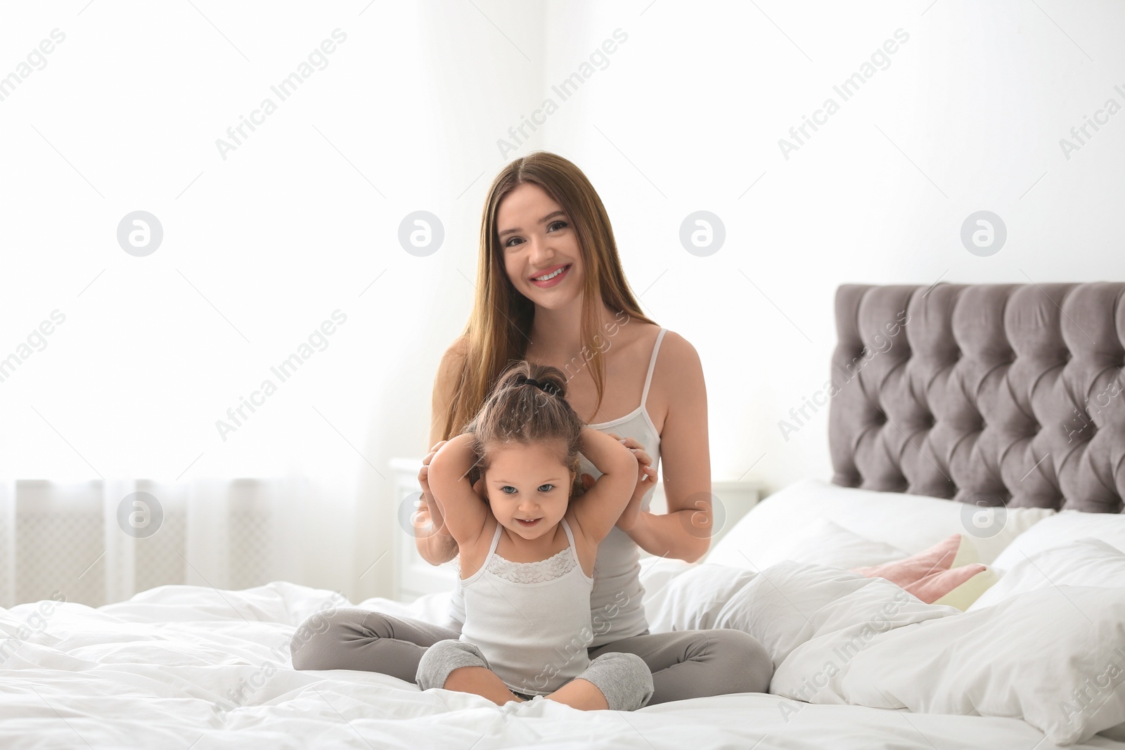 Photo of Happy mother with little daughter in bedroom