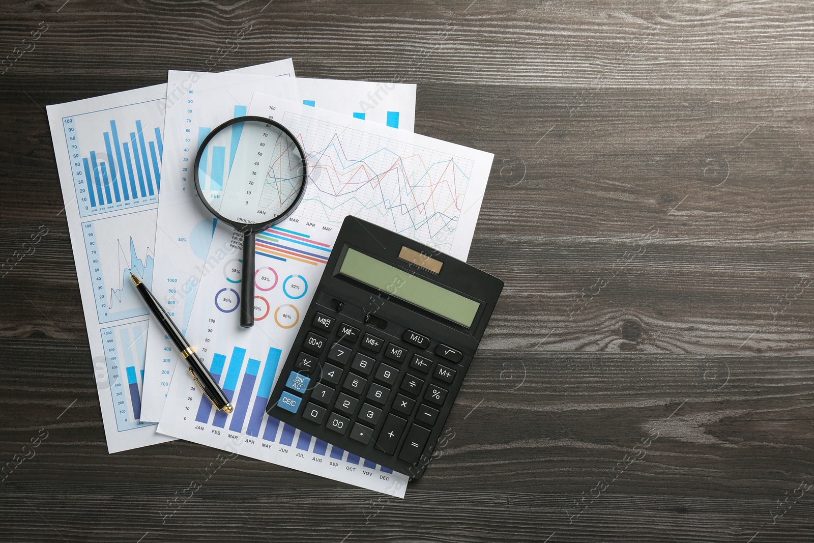 Photo of Accounting documents, magnifying glass, calculator and pen on wooden table, top view. Space for text