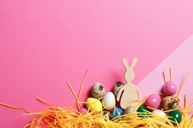 Photo of Flat lay composition of Easter bunny figure and eggs on color background, space for text