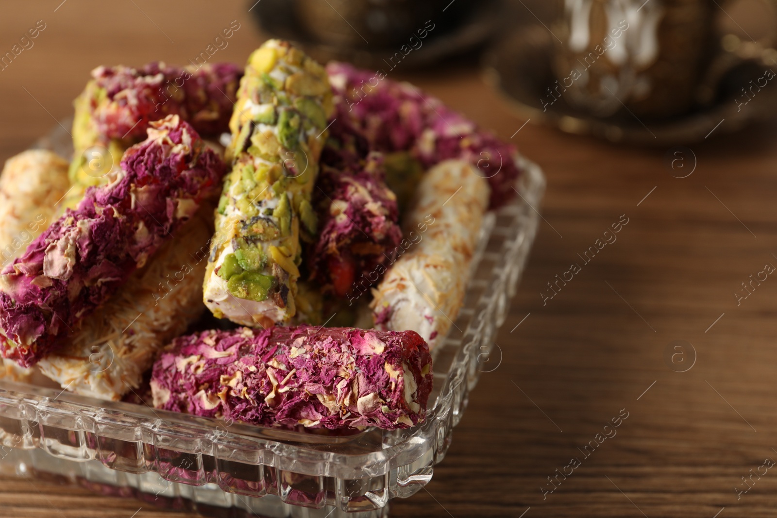 Photo of Turkish delight dessert on wooden table, closeup. Space for text