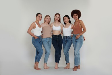 Photo of Group of beautiful young women on light grey background