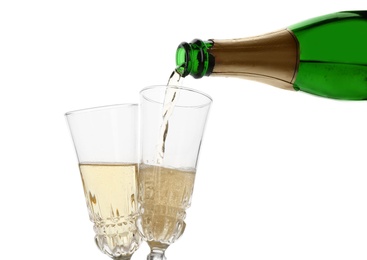 Photo of Pouring champagne from bottle into glass on white background