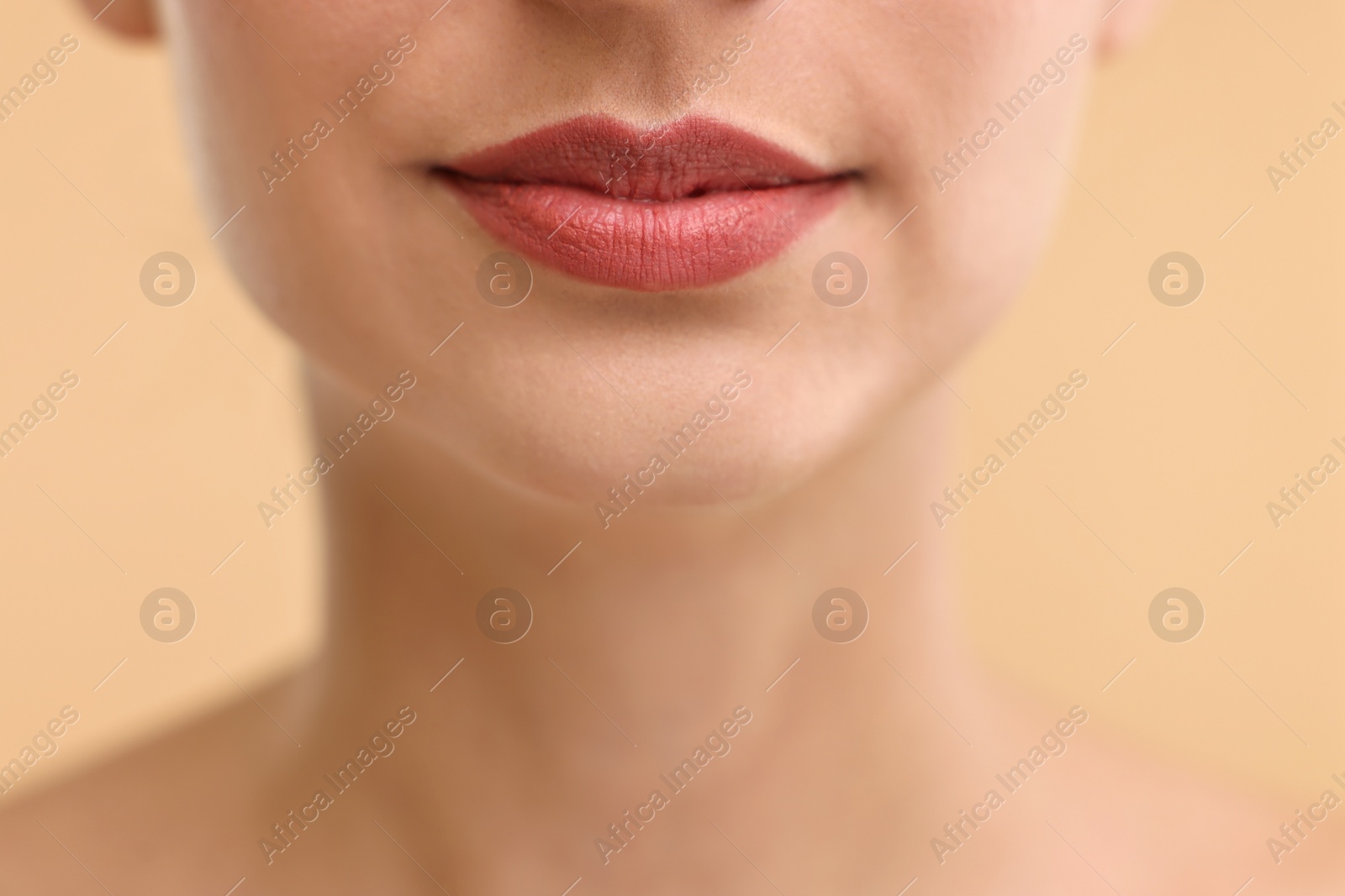 Photo of Woman with beautiful lips on beige background, closeup