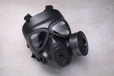 Photo of One gas mask on grey textured background, top view